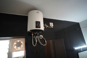 A white ceiling-mounted device with a control panel, connected to multiple cables. - Vaga Dreams (Vagamon)