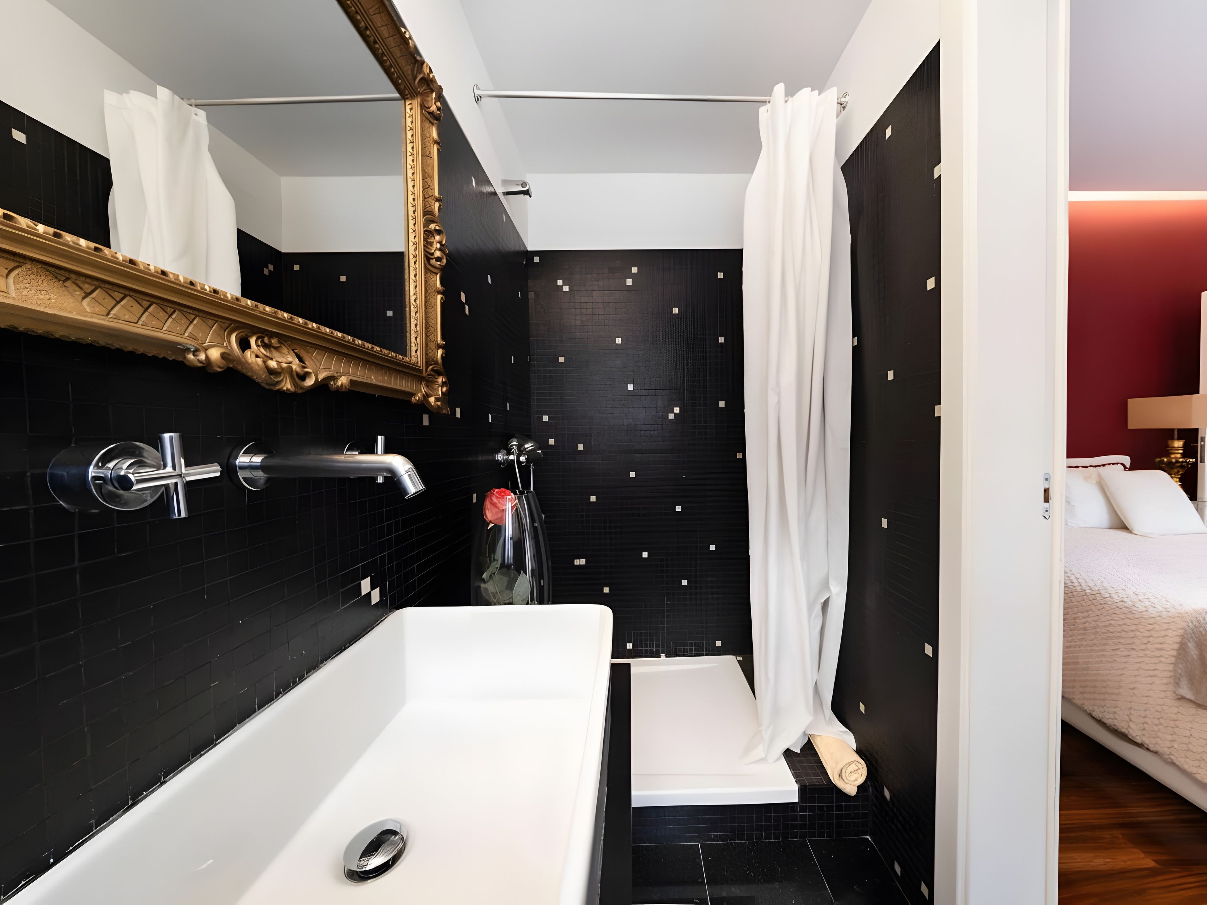 A modern bathroom with a large bathtub, a shower area, and a separate toilet.
