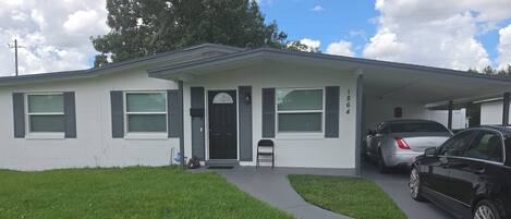 A single-story house with a garage, a front porch, and a driveway.