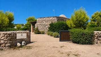 A stone building with a sign indicating it is a historical site.