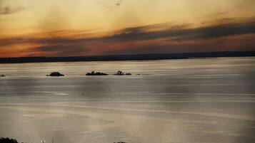 A large body of water with distant land and a cloudy sky.
