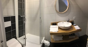 A modern bathroom with a glass shower enclosure, a wooden vanity with a large sink, and a mirror. - Chambre Poisson: Between Land and Sea (Lampaul-Guimiliau)