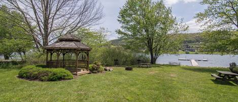 A gazebo, picnic tables, and a lake view.