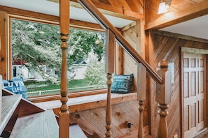 A wooden staircase with a view of a house and trees outside. - Long Lake Extended-Stay Furnished 30-Day+ Home (Ingleside)