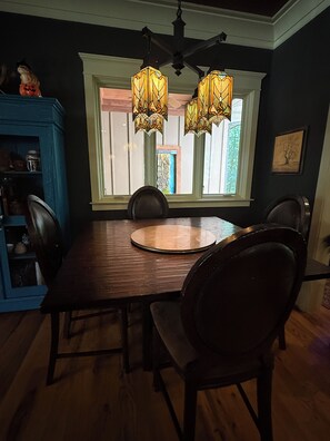 A dining area with a wooden table, four chairs, and two hanging lamps. - Secluded Lake Norman Waterfront Luxury, 4BR, 5.5 Baths with Home Theater (Mooresville)
