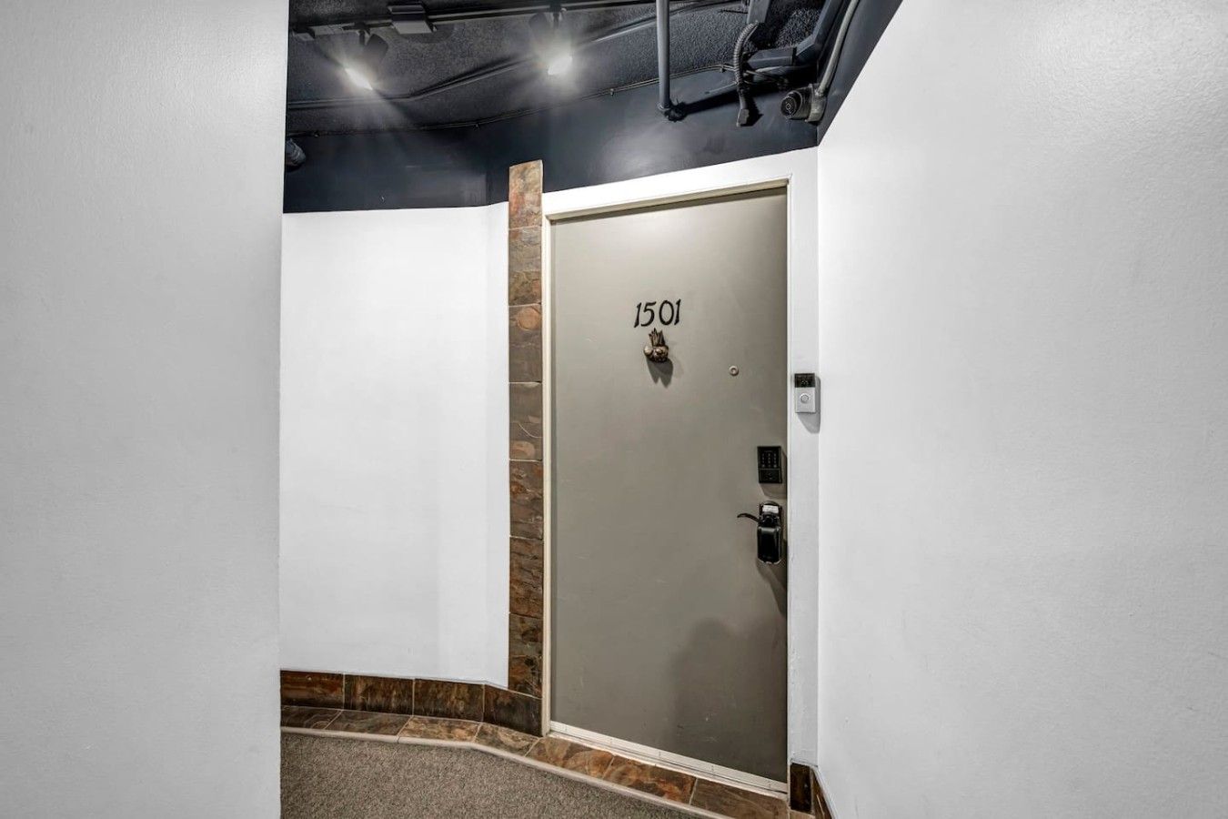 A hotel entrance with a door marked '1501' and a keypad lock.