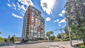 A multi-story building with a modern design, featuring balconies and large windows. - Reno Penthouse | Private Balcony | Mountain Views (Reno)