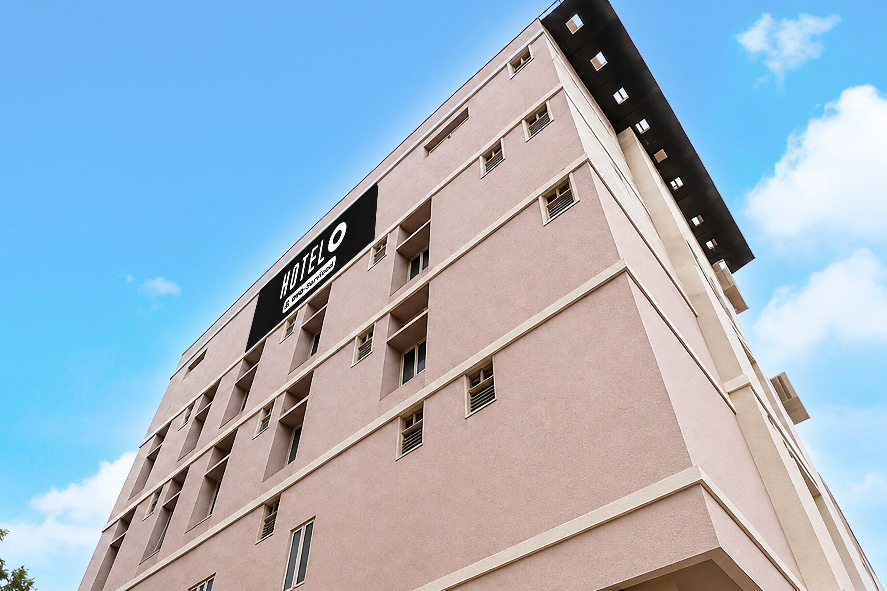 A multi-story hotel building with a prominent sign on the facade.
