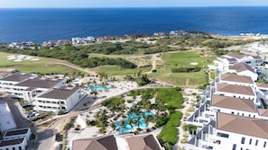 A resort with multiple buildings, a swimming pool, and a golf course. - The Reef Superior at Blue Bay (Blue Bay)