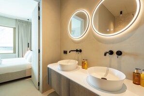 A modern bathroom with two sinks, a mirror, and a window. - The Reef Superior at Blue Bay (Blue Bay)