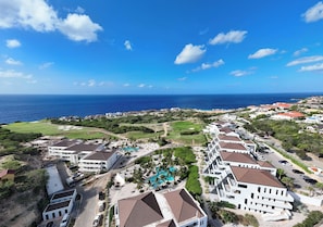 A coastal resort with multiple buildings, a swimming pool, and a view of the ocean. - The Reef Superior at Blue Bay (Blue Bay)