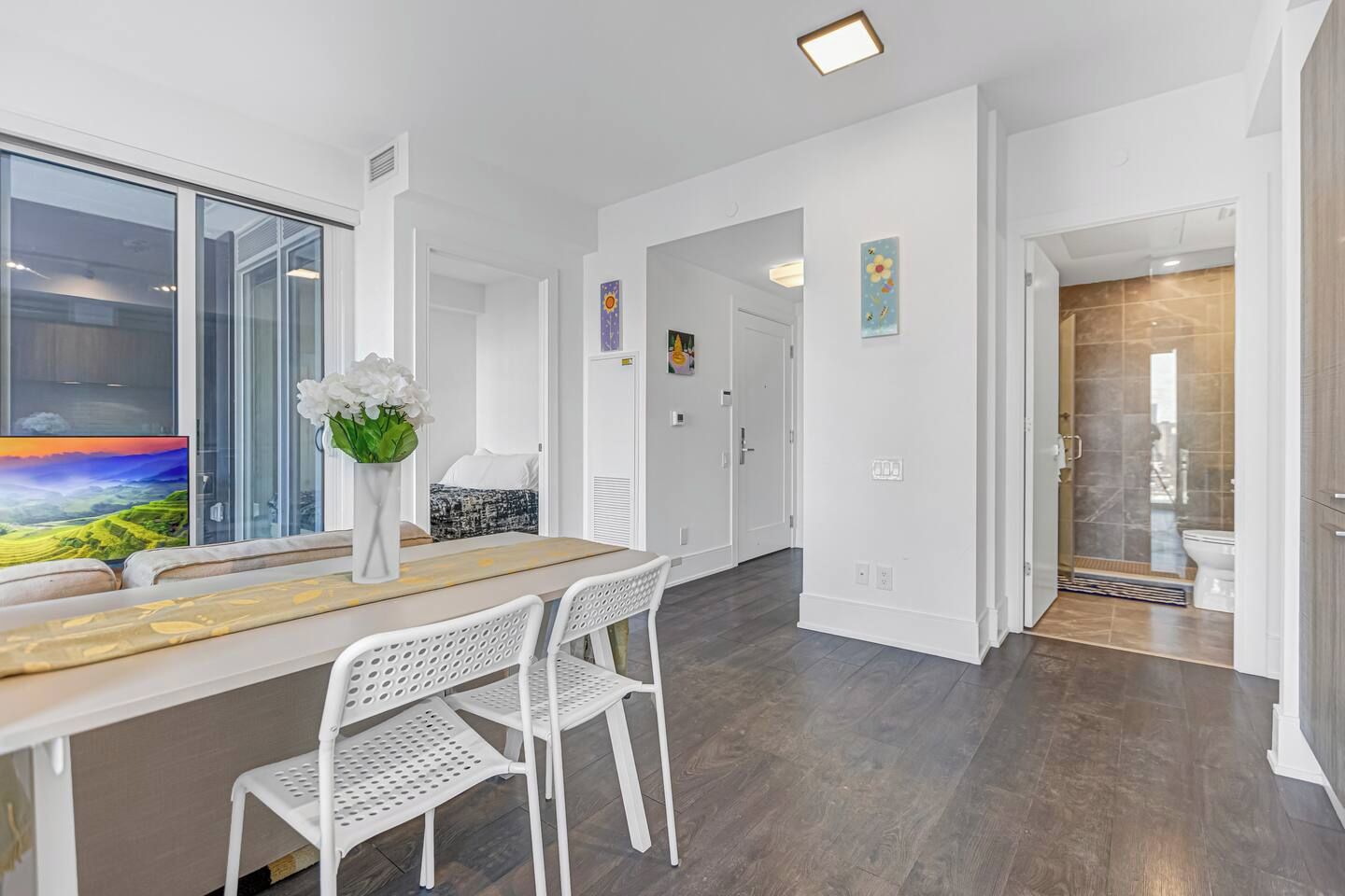 Ein modernes Interieur mit Essbereich, weißen Wänden und Blick auf eine reizvolle Landschaft.