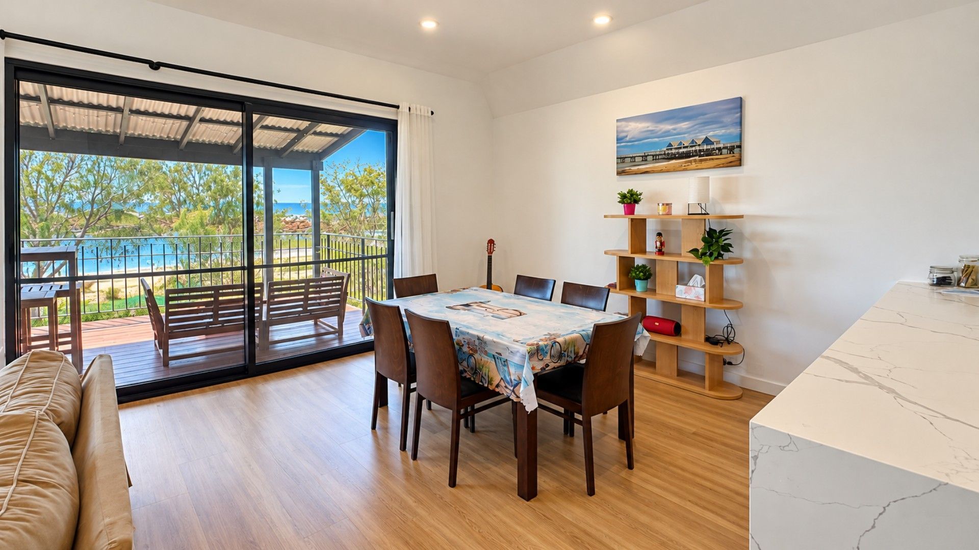 A dining area with a table, chairs, and a view of the outdoors.
