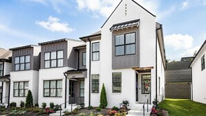 A modern multi-story residential building with a white facade, multiple windows, and a well-maintained lawn. - The Rebel Hideout, Pool+3BR | Velvet Ditch Villas (Oxford)