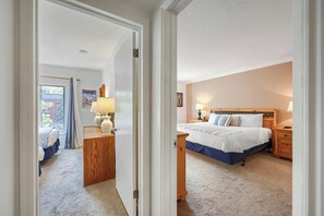 A hotel room with a bed, bedside tables, a lamp, and a view through an open door. - Main Street Walk to Everything and Town Lift 146 (Park City)