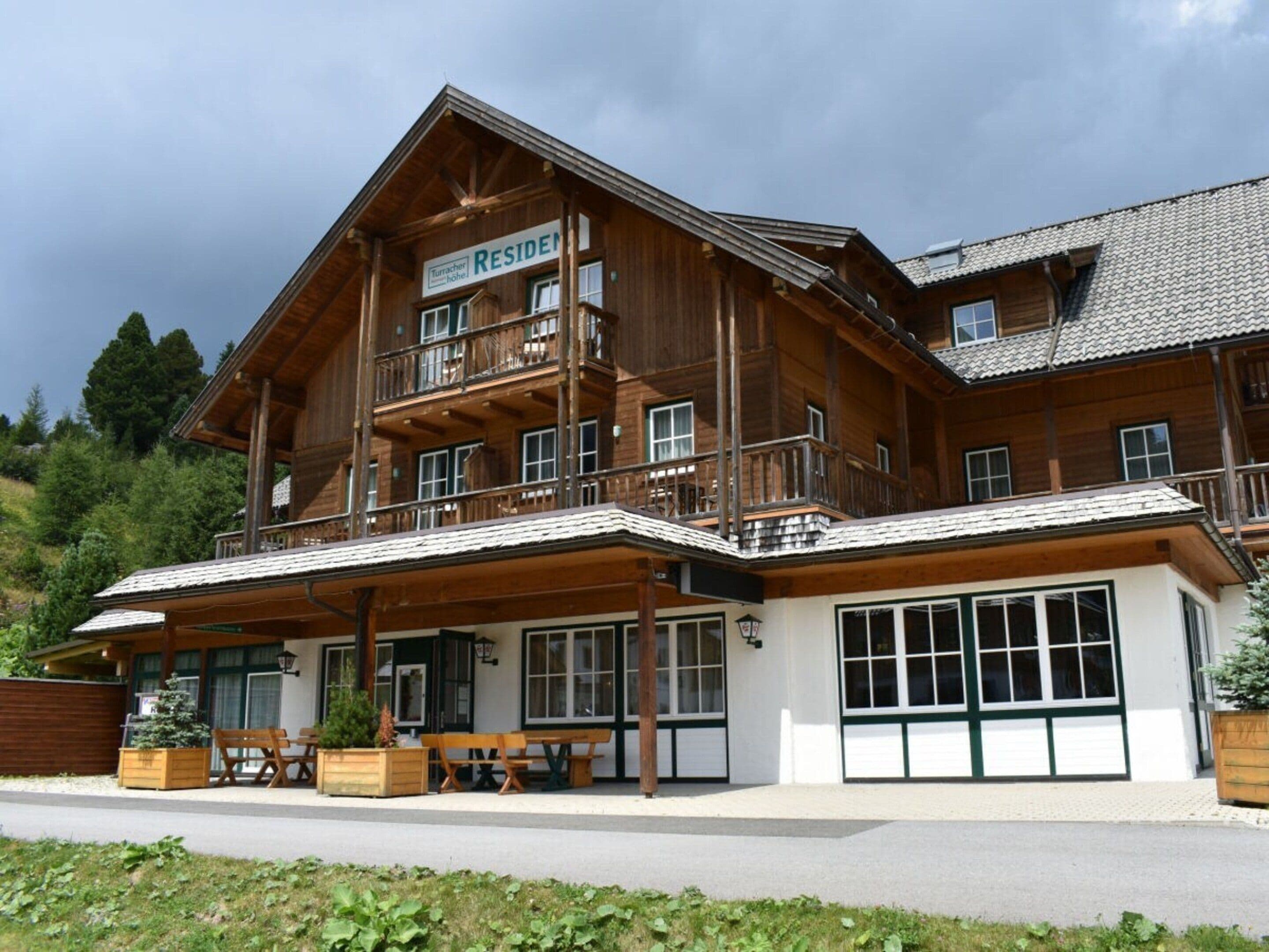A large wooden building with a sign that reads 'RESIDEN'.