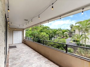 A balcony with hexagonal tiles, a metal railing, and string lights. - Kailua-Kona, Holualoa Bay Villas, Spacious 4 BR, Beachfront, Sleeps 12 (Kailua-Kona)