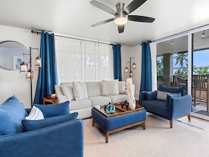 A modern living room with a sofa, two armchairs, a coffee table, and a ceiling fan. - Kailua-Kona, Holualoa Bay Villas, Spacious 4 BR, Beachfront, Sleeps 12 (Kailua-Kona)