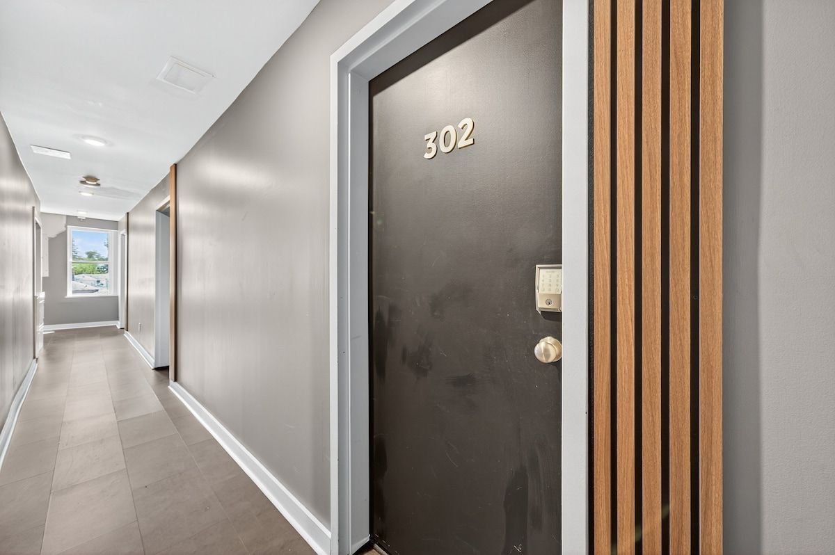 A hallway with a door labeled '302' and a keypad lock.