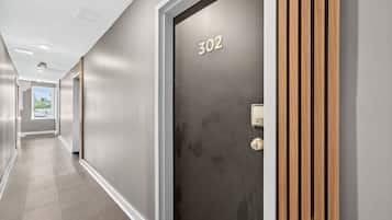 A hallway with a door labeled '302' and a keypad lock.