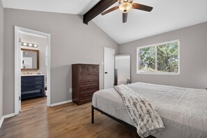 A bedroom with a bed, a dresser, a vanity with lights, a ceiling fan, and a window with blinds. - New! East Austin 4BR w/Fenced Yard, Patio + Dogs (Austin)