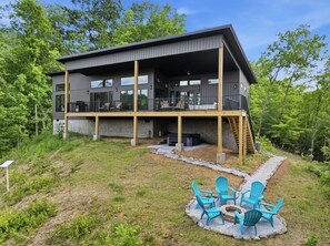 A modern two-story house with a balcony and outdoor seating area. - The Laurel & Sky ~ Smoky Mountains (Bryson City)