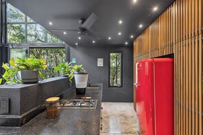 A modern kitchen with a red refrigerator, a coffee machine, and a sink. - Tree60 - Jungle Villa with Private Rooftop & Wood-Hot Tub (Tulum)