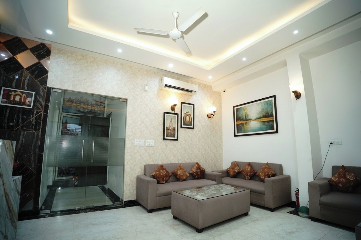 A modern living room with a sofa set, a coffee table, a ceiling fan, and artwork on the walls.