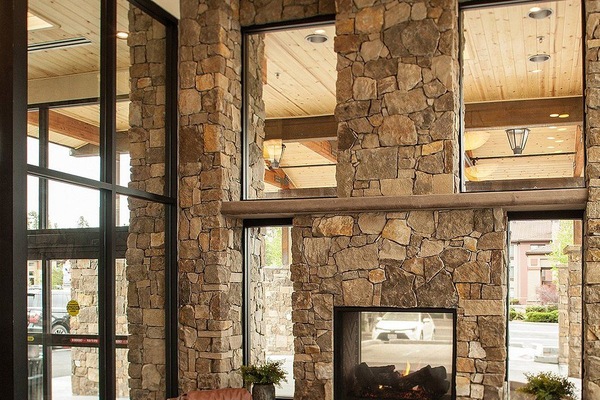 Unwind by the soaring stone fireplace in airy lobby.