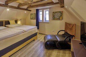 Un dormitorio con una cama, un escritorio con computadora y un ventanal.