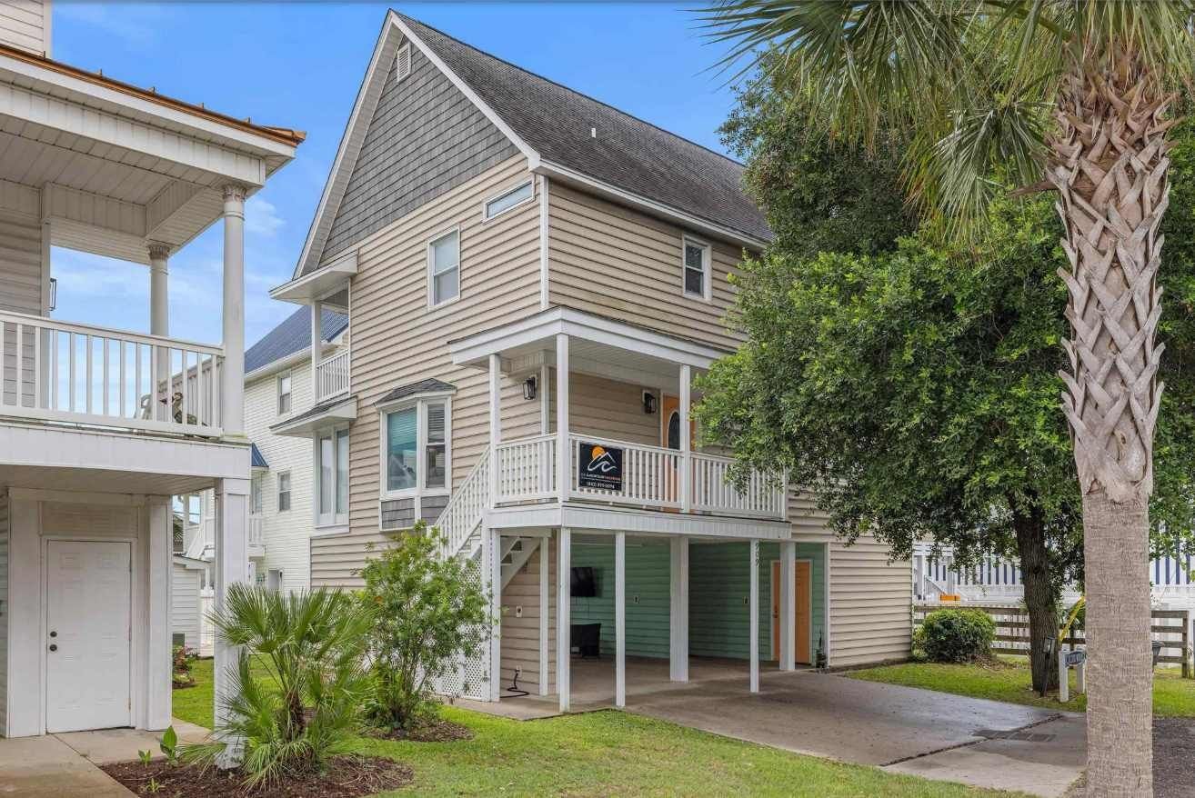 A two-story house with a covered porch and a garage.