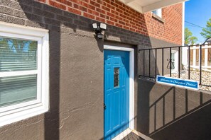 A blue door with a sign reading 'Welcome to Cheyenne Plains!' - Cheyenne Plains 2 bedroom (Cheyenne)