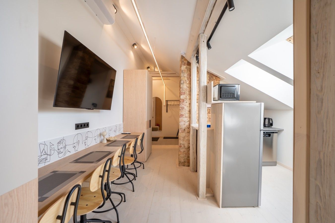 A modern kitchen with a built-in refrigerator, a microwave, and a coffee maker.