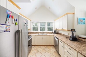 A kitchen with white cabinets, a stainless steel refrigerator, a coffee maker, and a blender. - Golf Views, Private Pool/Spa, Community Amenities! (Corolla)