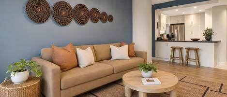 A modern living room with a sofa, coffee table, and decorative wall art.