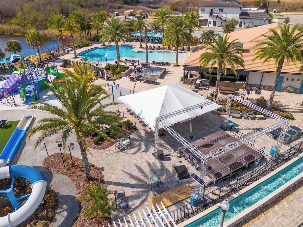 Een resort met meerdere zwembaden, een glijbaan en een overdekt terras.