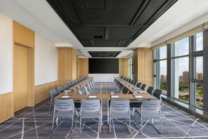 A conference room with a long table, chairs, and a large window. - Four Points By Sheraton Kashgar (Kashgar)