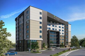 A multi-story hotel building with a modern architectural design, featuring a prominent entrance and a parking area. - Element By Marriott Short Pump (Richmond)