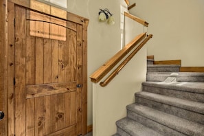 A wooden door with a modern staircase and wall-mounted lighting. - Buffalo Peaks - Where your Adventure Begins (Driggs)