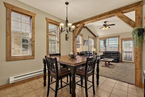 A spacious living area with a dining table, chairs, and a fireplace. - Buffalo Peaks - Where your Adventure Begins (Driggs)