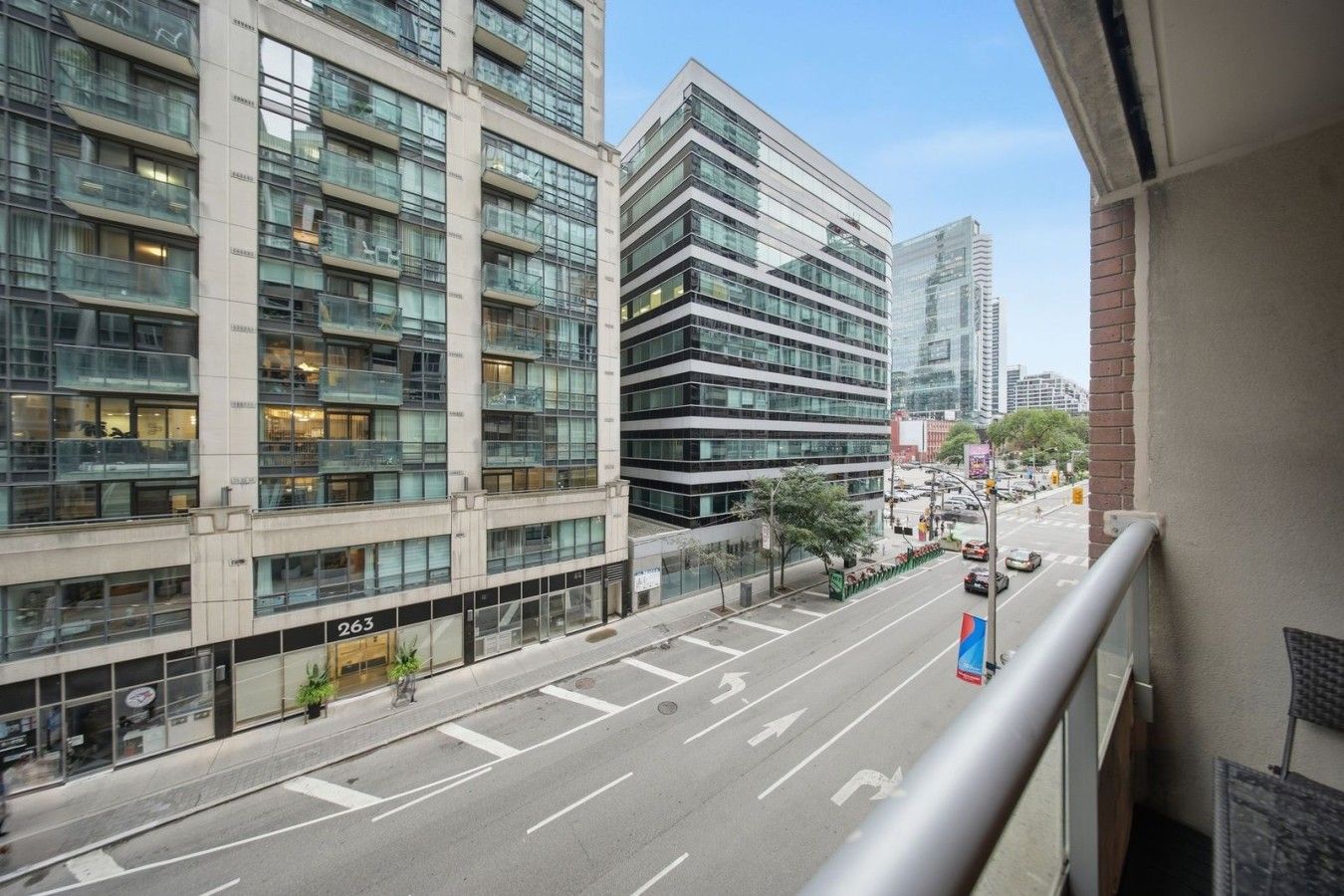 A multi-story building with large windows and a clear view of the street below.