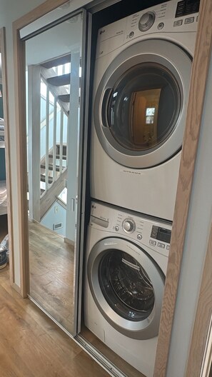 A laundry room with two stacked front-loading washing machines.