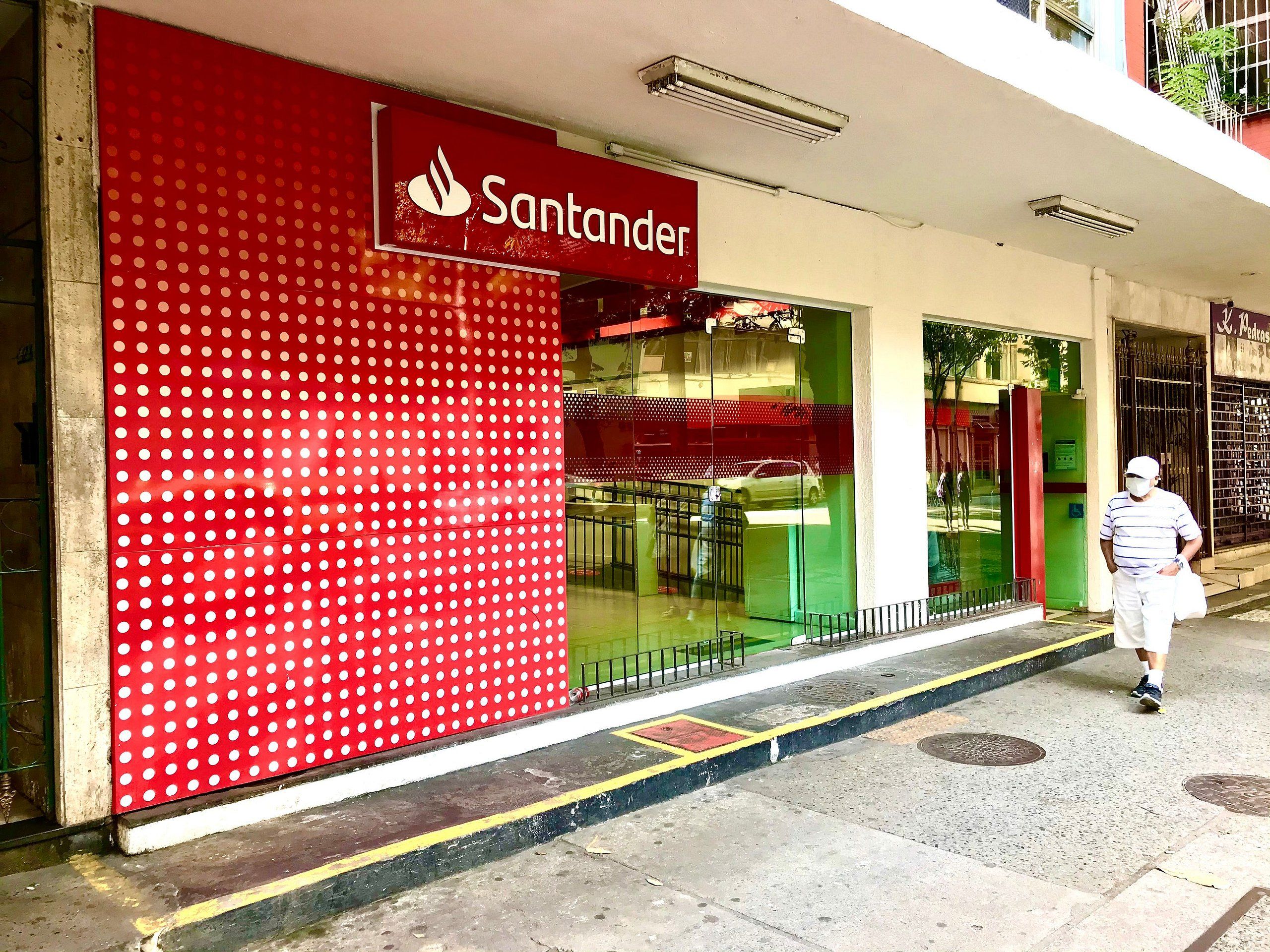 A storefront with a red facade and a visible sign reading "Santander".