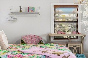 A bedroom with a bed, a chair, a small table, a window with blinds, and a shelf with items. - Farm Stay, 5beds / 4.5 baths, Palm Tree, Alpaca & Llama Farm, 5 Acres (West Palm Beach)