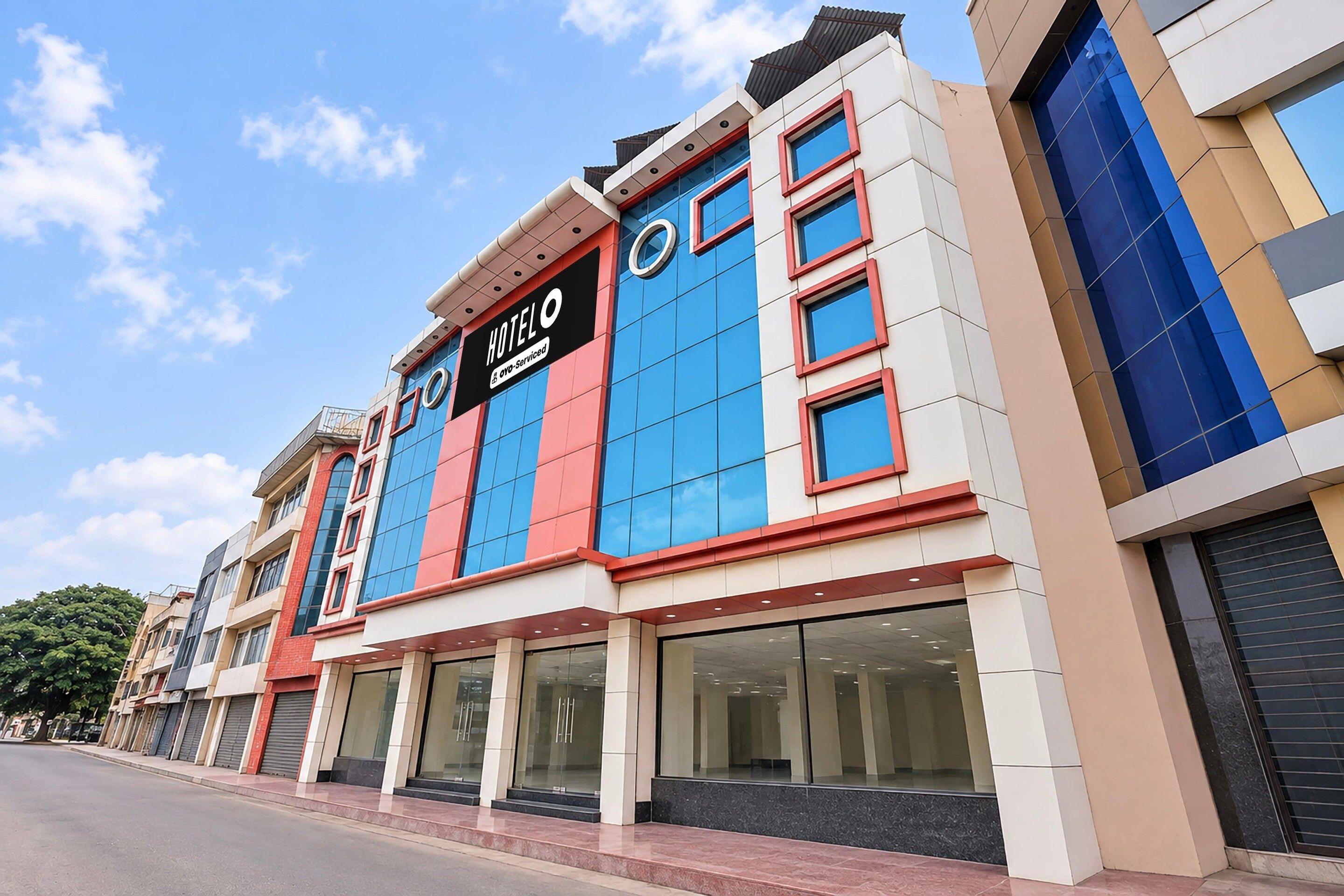 A hotel with a modern facade, large windows, and a prominent sign.