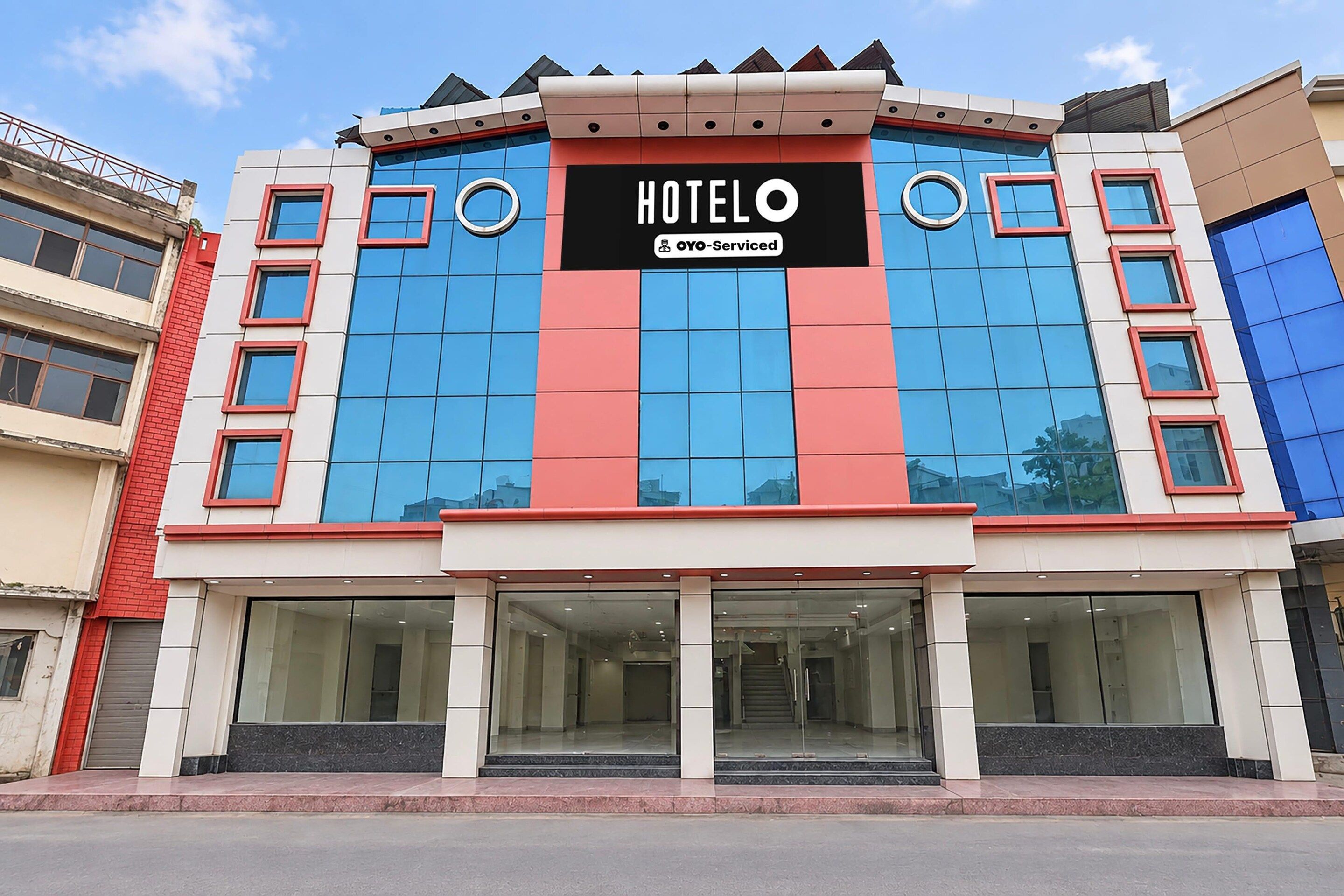 A hotel building with a prominent sign reading 'HOTEL' and 'OYO-Serviced'.