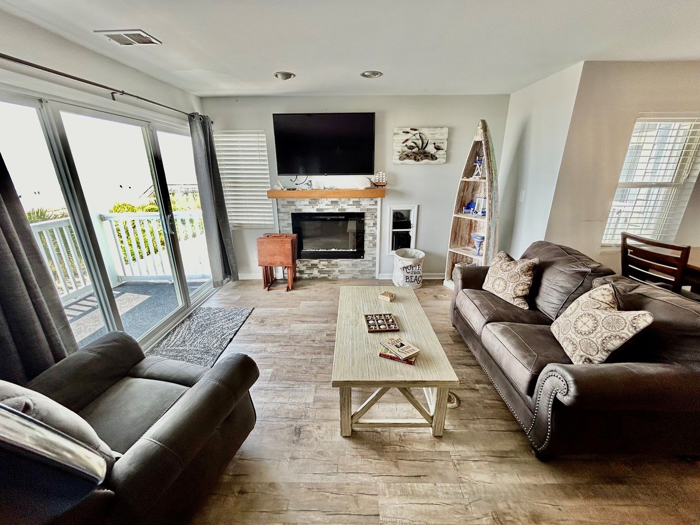 A living room with a fireplace, a sofa, a coffee table, and a television.