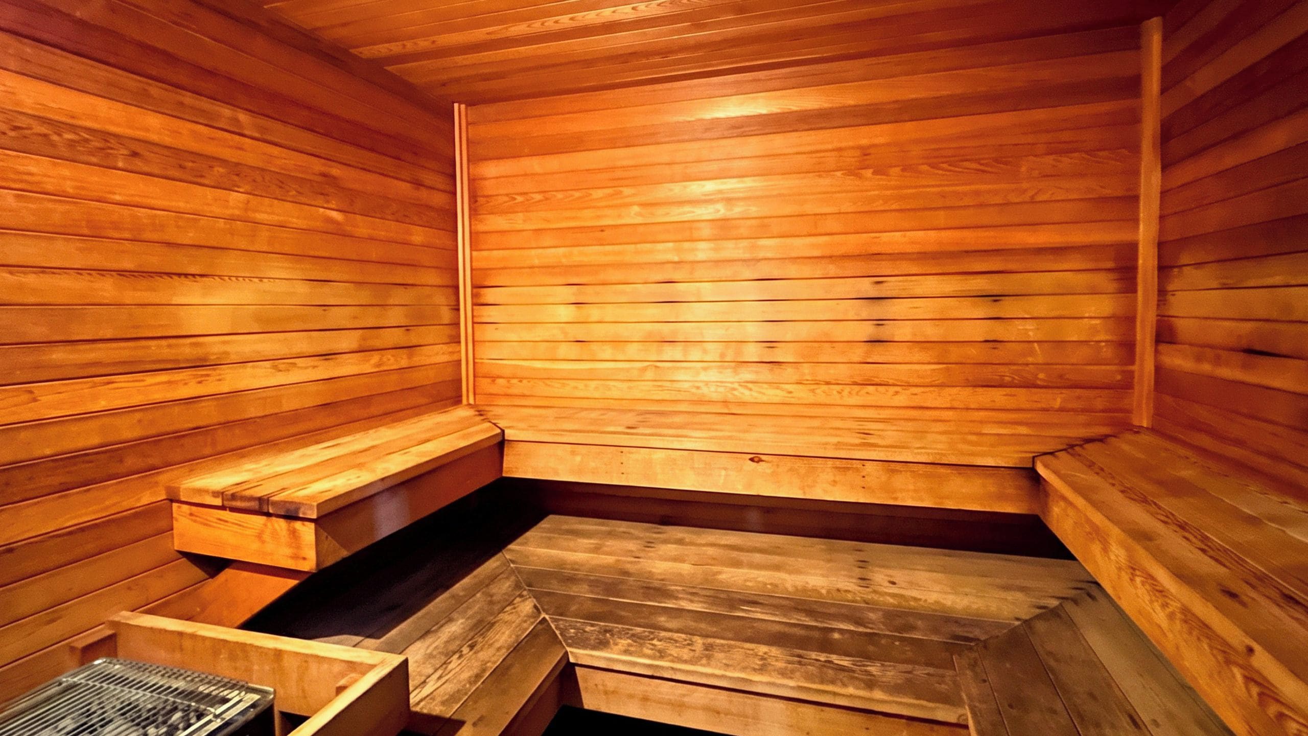 A sauna with wooden benches and a bench seat.