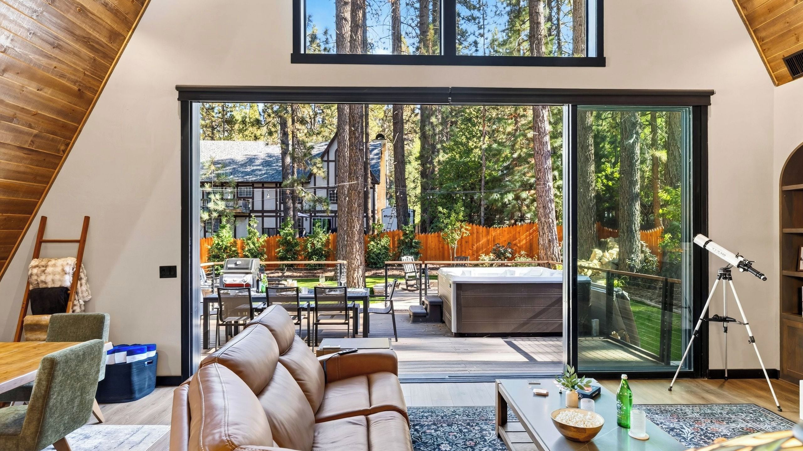 A modern interior with a large sliding glass door leading to an outdoor patio area.