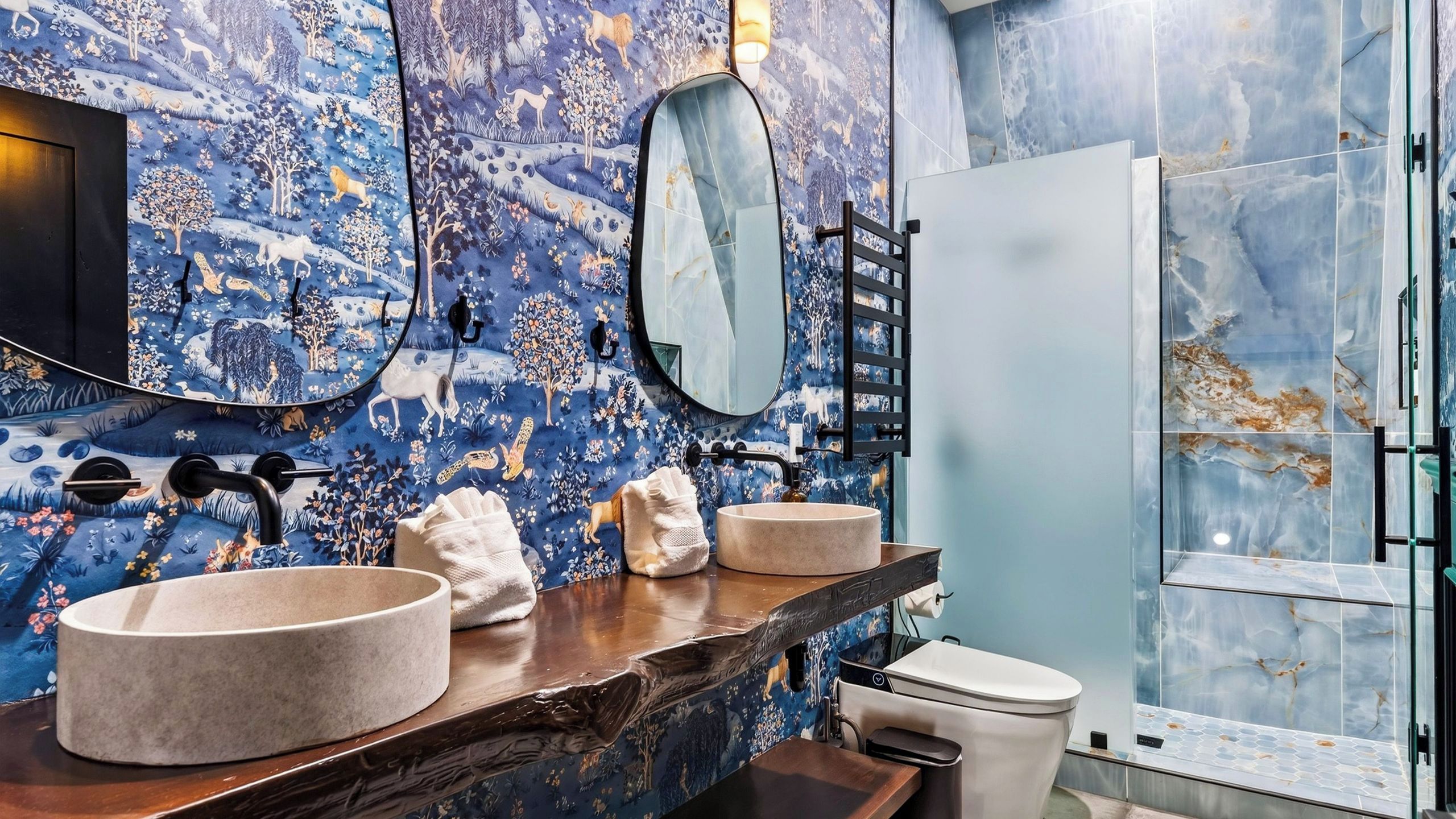 Un baño con un espejo grande, dos lavamanos y una ducha.